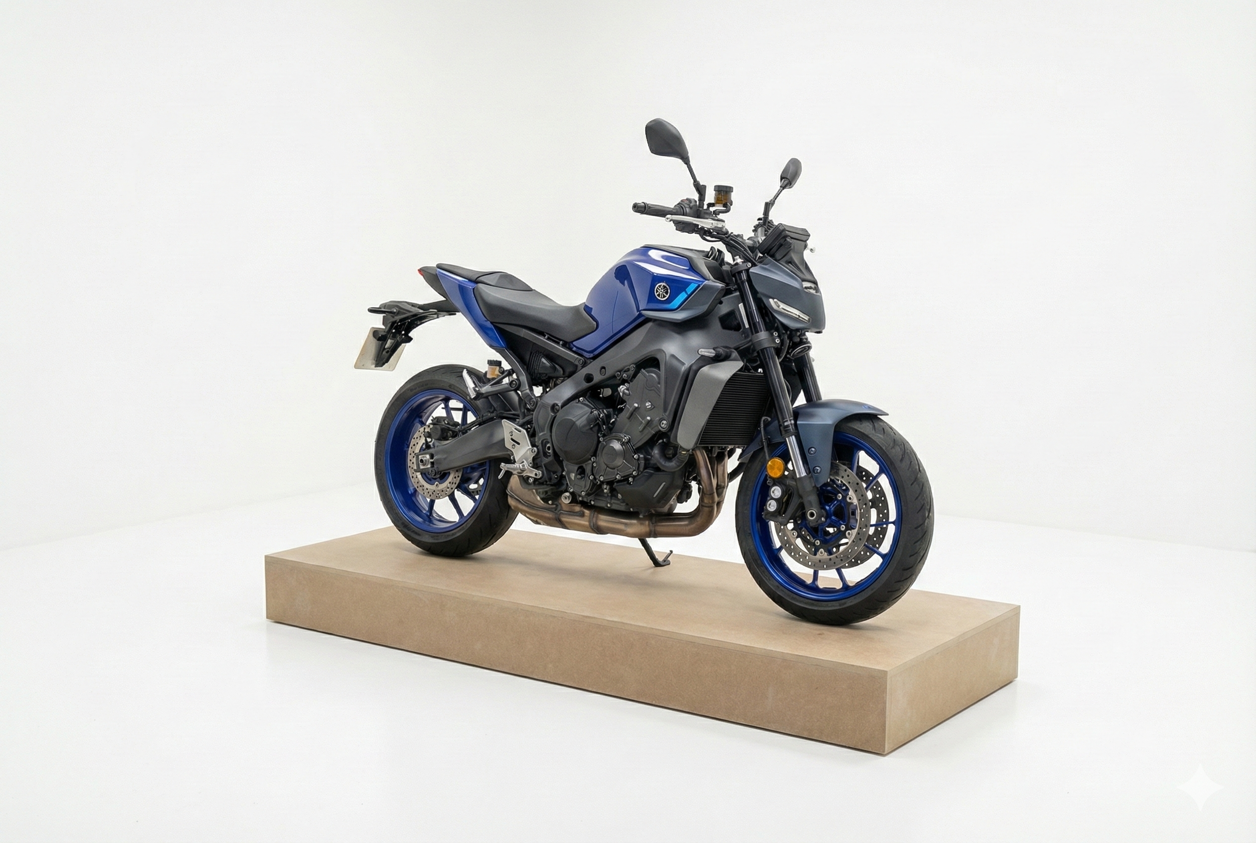 A robust, light-brown flatpack display plinth supporting a 200kg blue Yamaha motorcycle in a white studio setting, demonstrating high load-bearing capacity for retail showrooms.